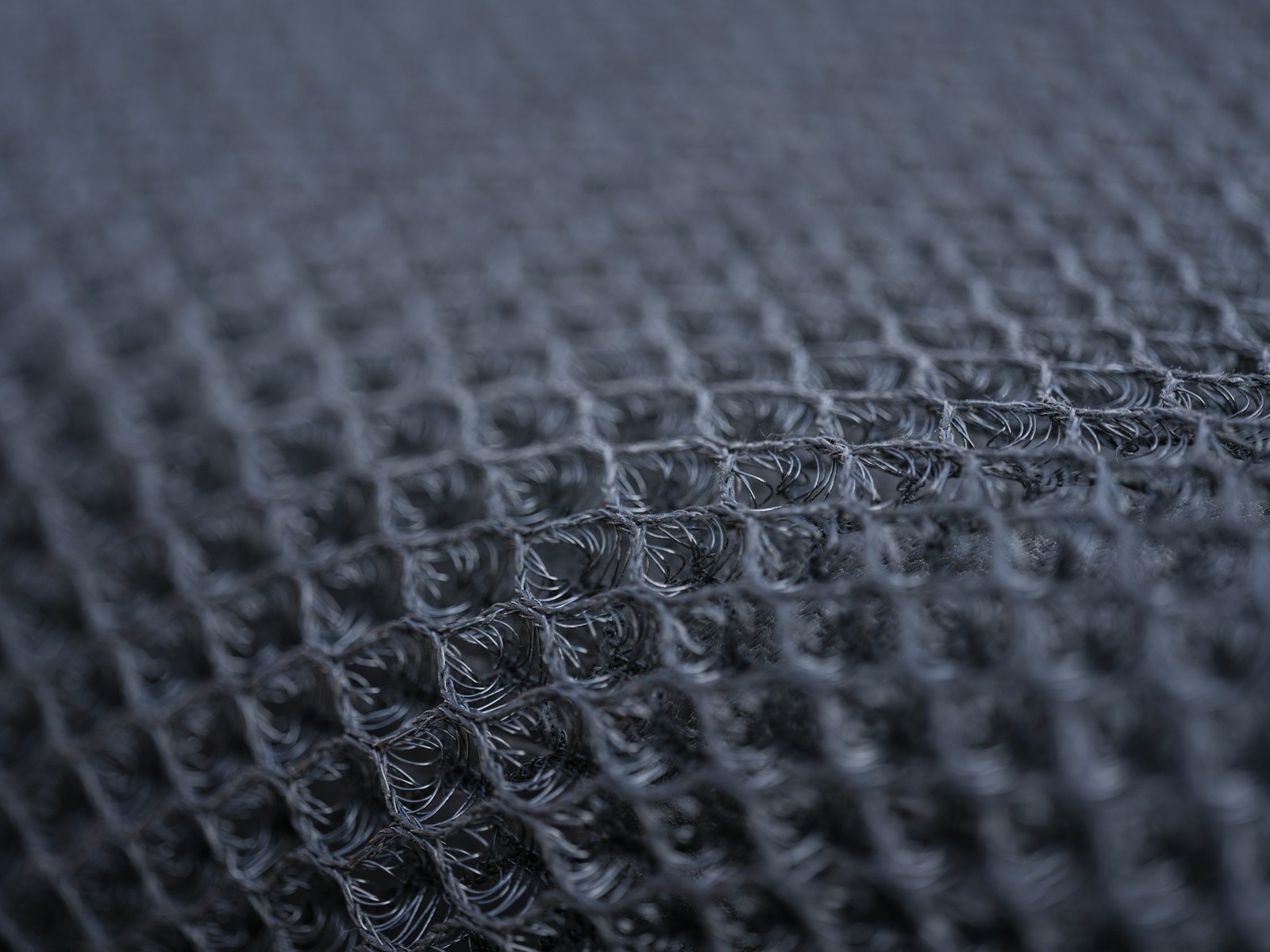 Abstract close-up of layered textile fibres and recycled material surfaces.