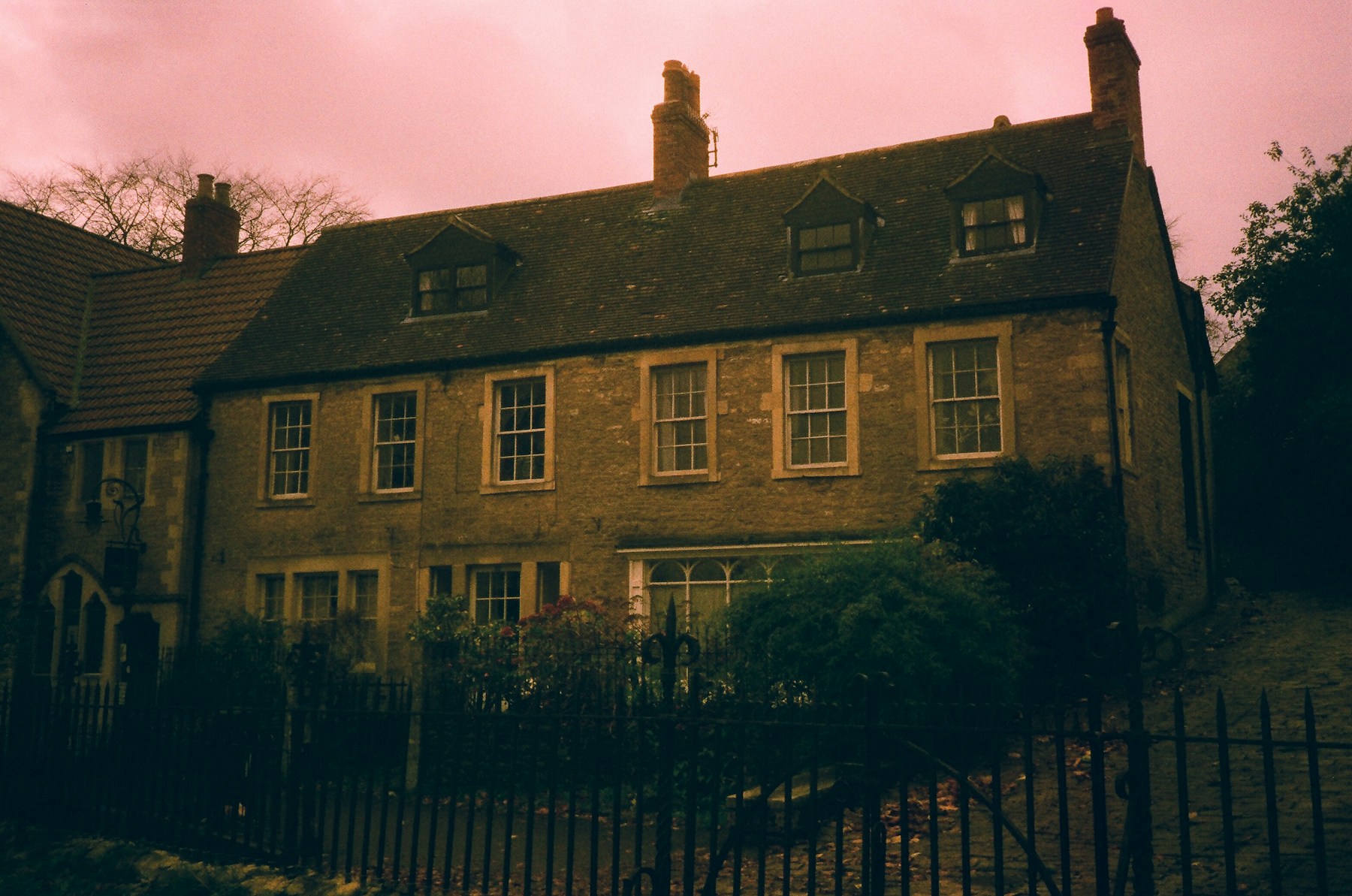 Restrained heritage architecture exterior with stone facade and classic windows.